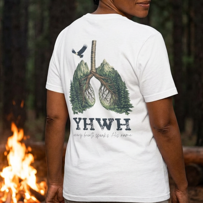 Person wearing a white Christian graphic t-shirt featuring a nature-inspired lung design and the phrase “YHWH – every breath speaks His name” on the back.