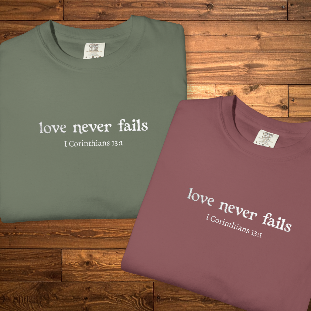 Love Never Fails Tee | White Embroidery | 1 Corinthians Scripture T-Shirt