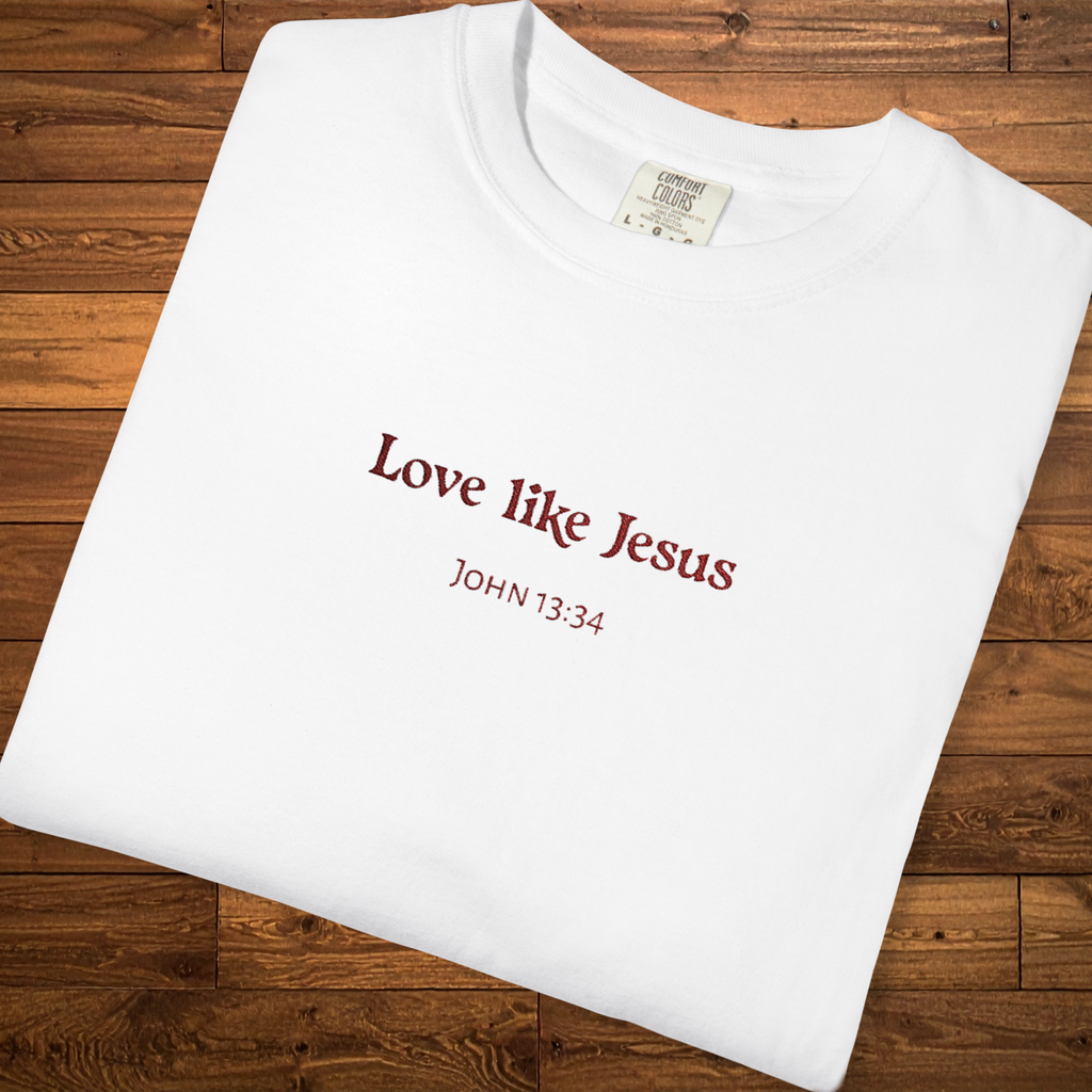 Faith-based garment-dyed t-shirt in white featuring the embroidered-style message “Love Like Jesus” with John 13:34 centered on the chest.