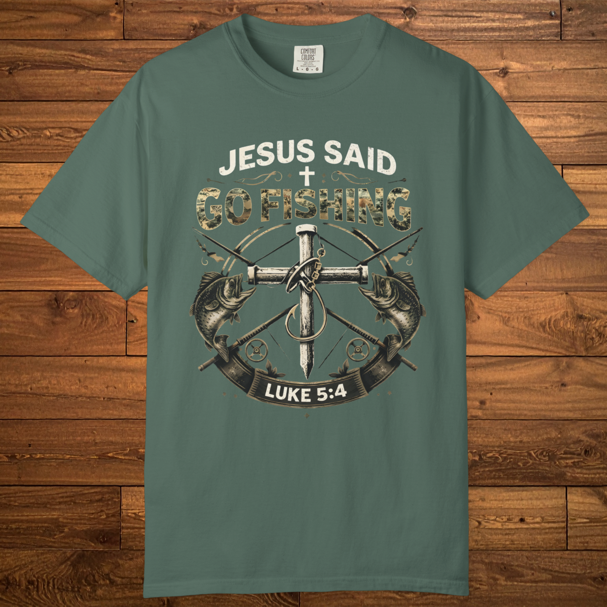 Christian fishing t-shirt featuring the phrase “Jesus Said Go Fishing” with bass fish artwork, a cross, fishing tackle, and Luke 5:4.