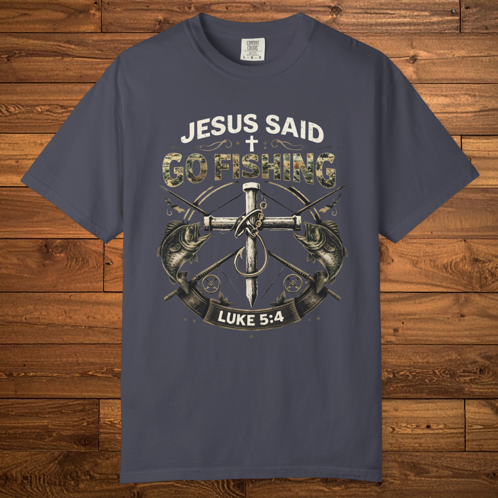 Navy Christian fishing t-shirt featuring the phrase “Jesus Said Go Fishing” with bass fish artwork, a cross, fishing tackle, and Luke 5:4.