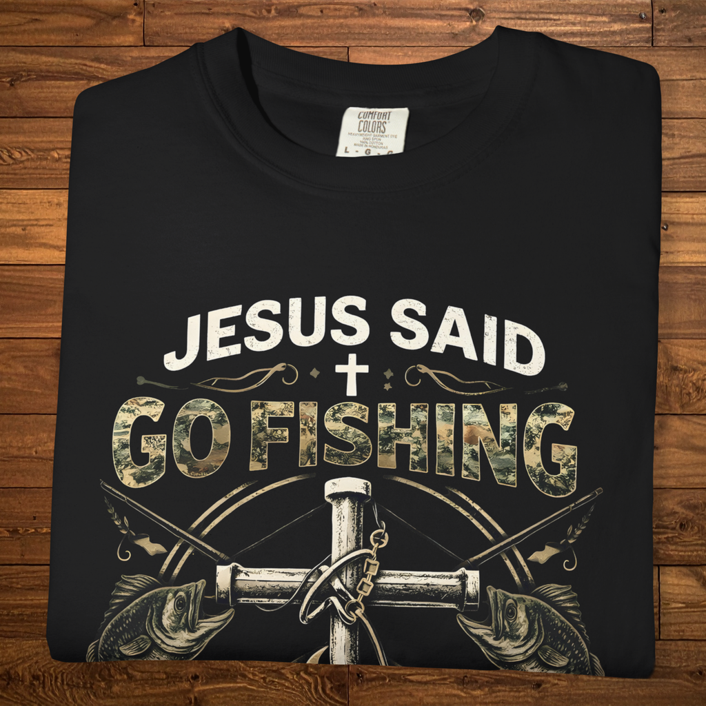 Black Christian fishing t-shirt featuring the phrase “Jesus Said Go Fishing” with bass fish artwork, a cross, fishing tackle, and Luke 5:4.