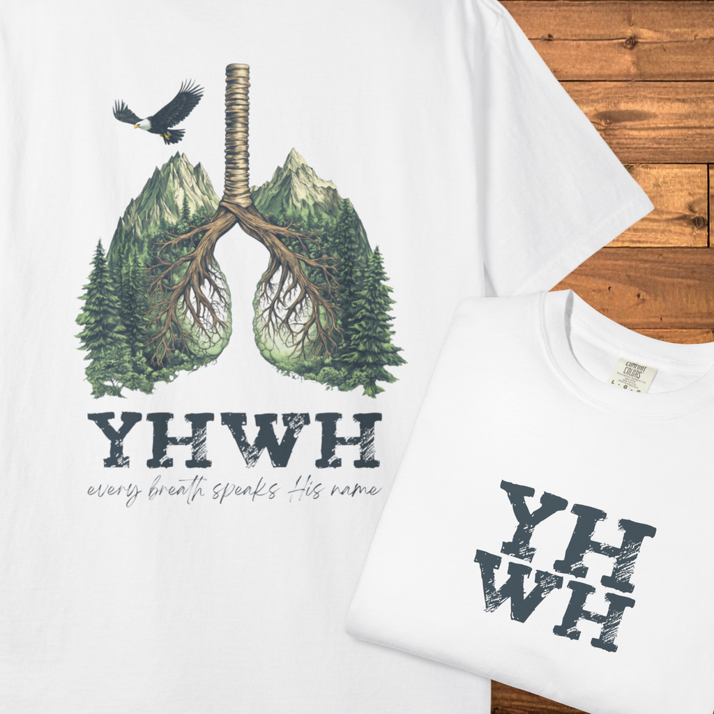 Back of a white faith-based t-shirt featuring lungs formed from mountains, trees, and roots above the phrase “YHWH – every breath speaks His name.”